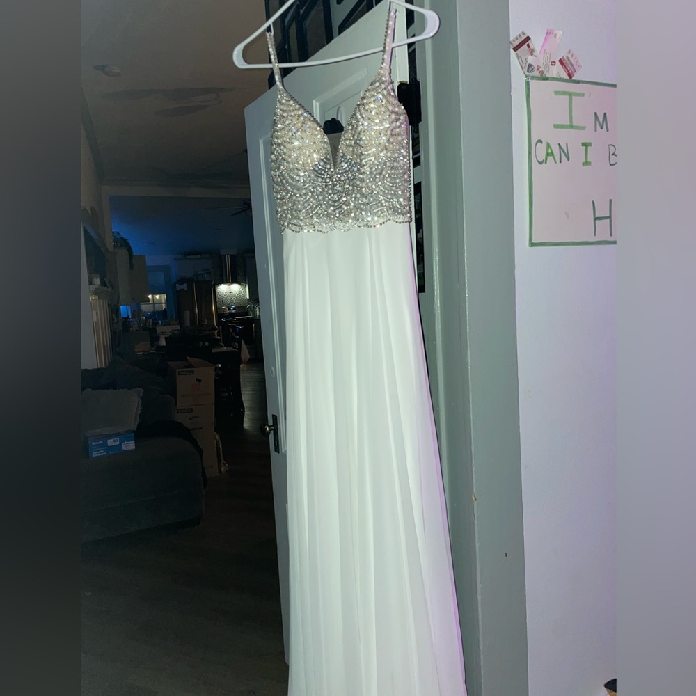 Beautiful white dress with diamonds on it.